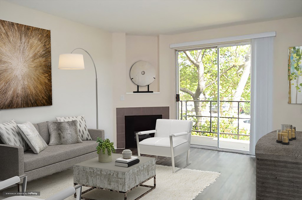 a living room with a couch and a chair and a fireplace