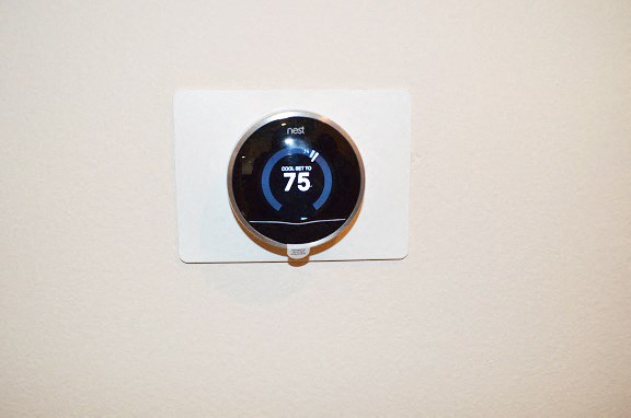 a digital thermostat on a white wall