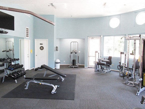 a gym with weights and other equipment in it