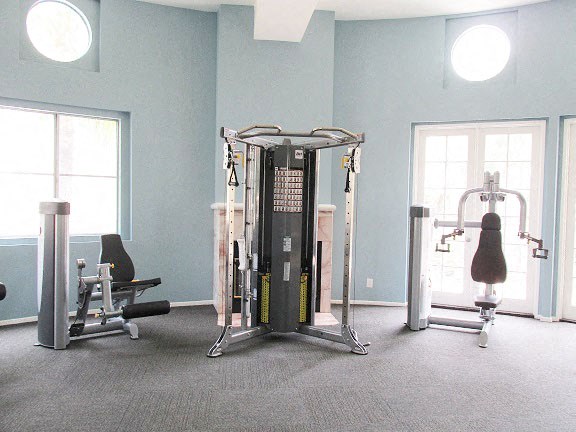 a gym with weights and other equipment in a room