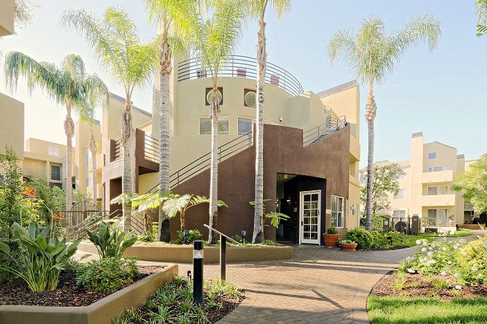 a building with a staircase and palm trees