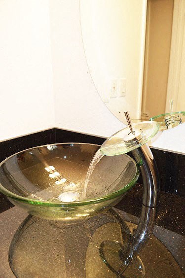 a glass bowl with water flowing out of it