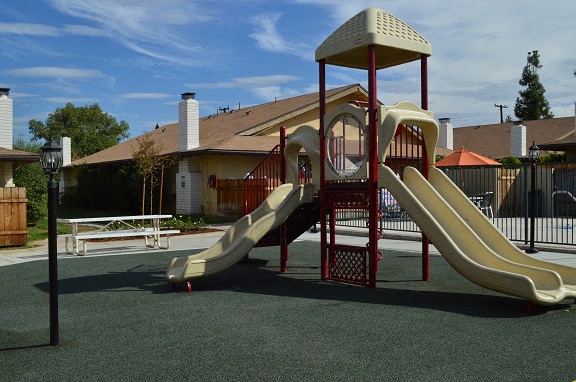 a playground with a slide in a park