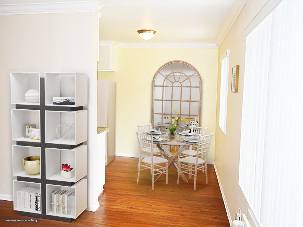 a dining room with a table and chairs and a bookshelf