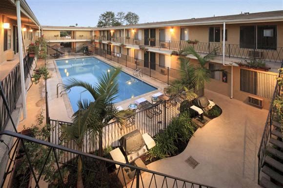 a swimming pool in the middle of a hotel courtyard