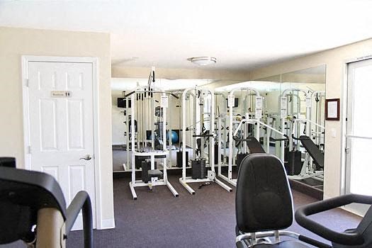 a gym with a bunch of exercise equipment in it