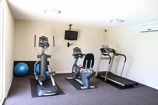 a group of exercise machines in a small room