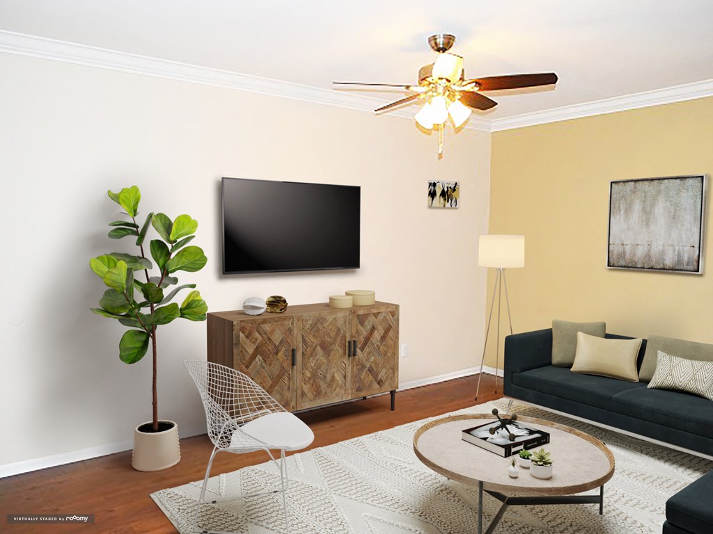 a living room with a couch and a tv on the wall