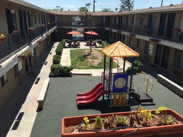 a courtyard with a playground and a play area