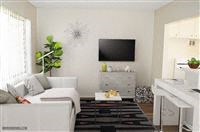 a living room with a white couch and a television