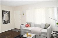 a white living room with a white couch and a table