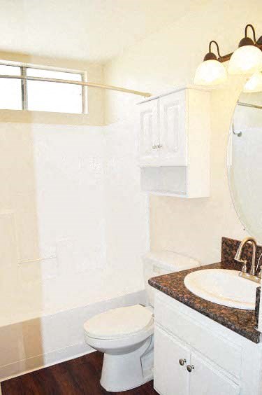a white bathroom with a toilet and a sink