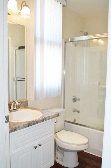 a bathroom with a toilet and a sink and a shower