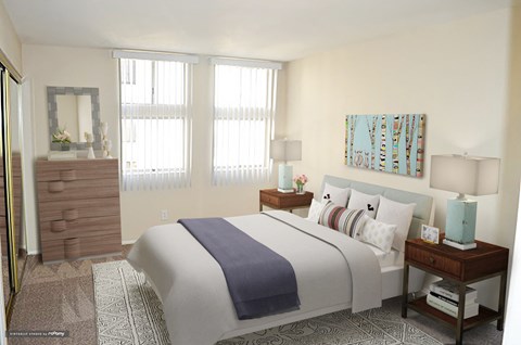 a bedroom with a bed and two windows