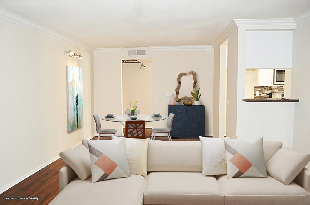 a living room with a couch and a table with chairs
