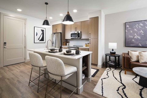 A modern kitchen with a dining table and chairs.