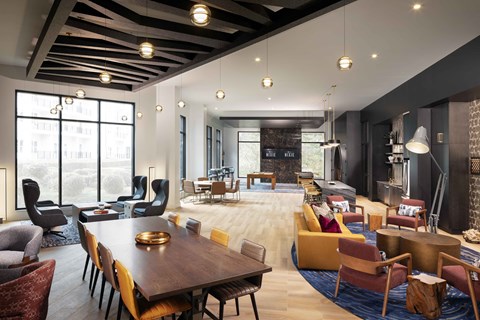 A modern living room with a large wooden table and comfortable seating.