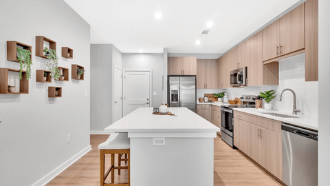 a white kitchen with wooden cabinets and a white counter top