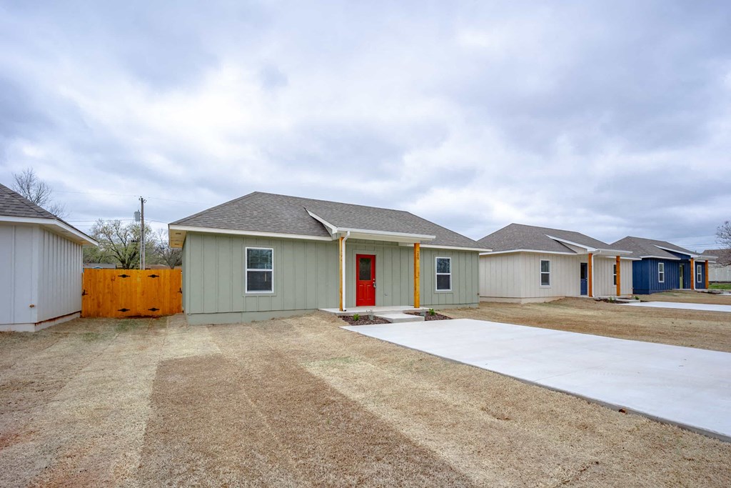a home with a red door and a white driveway