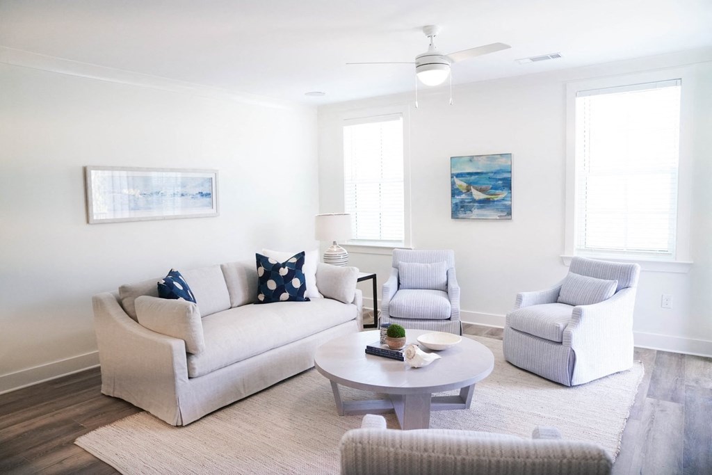 a living room with couches and chairs and a coffee table