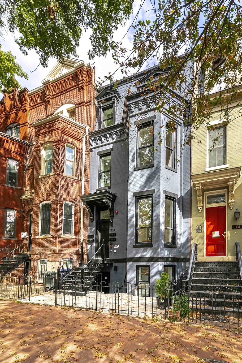 a row of houses with a red door and