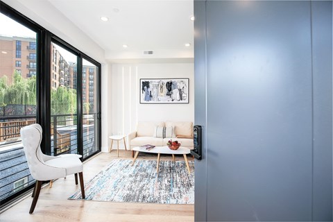 a living room with a couch and a sliding glass door