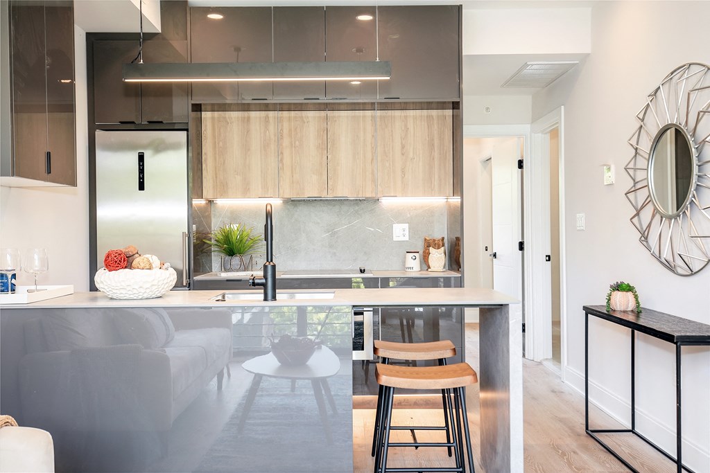 a kitchen with a large island with two stools