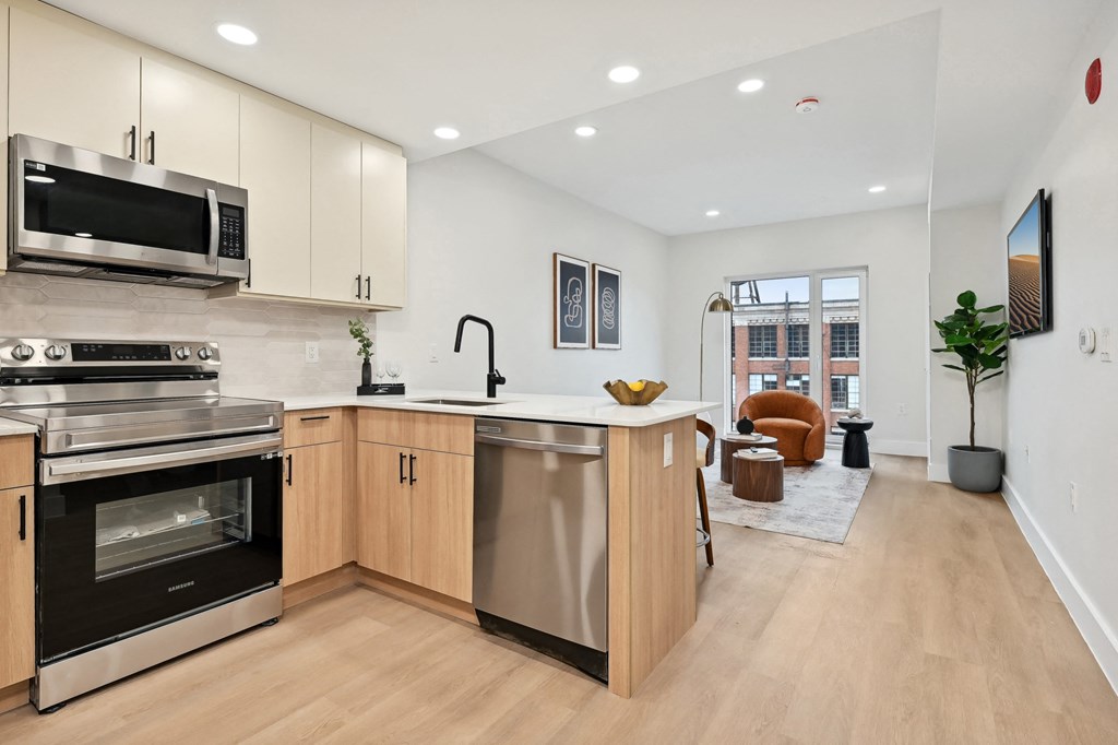 a large kitchen with an island and stainless steel appliances