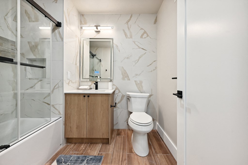 a bathroom with a toilet and a sink and a shower