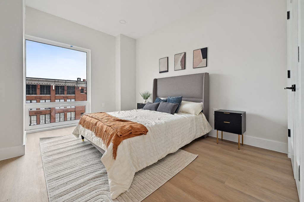 a bedroom with a large bed and a large window