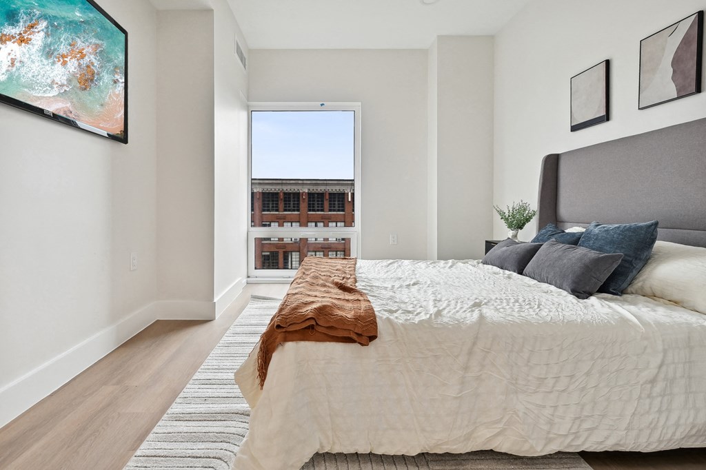 a bedroom with a large bed and a window