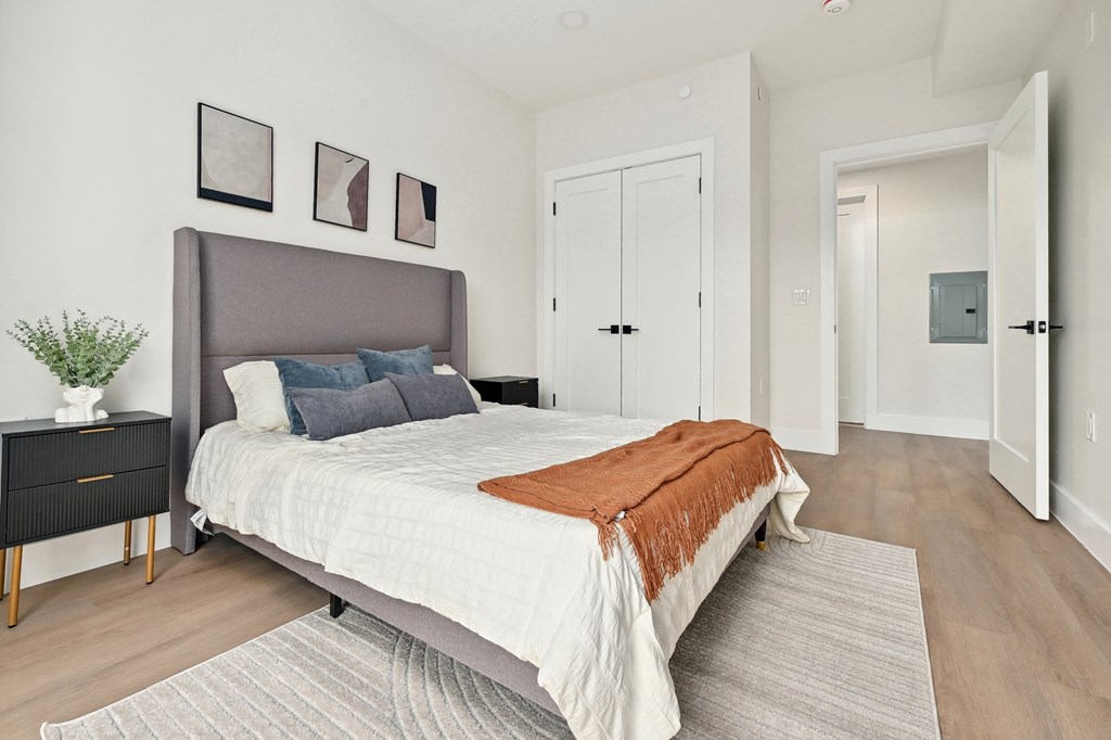 a bedroom with a large bed and a rug