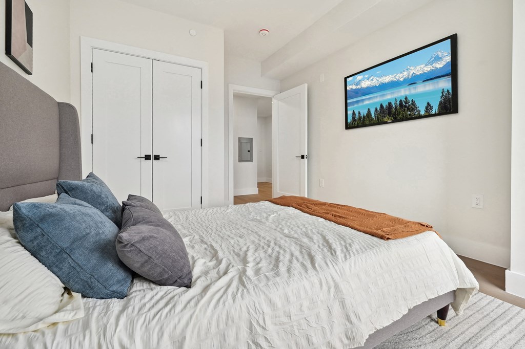 a bedroom with a bed with pillows and a couch