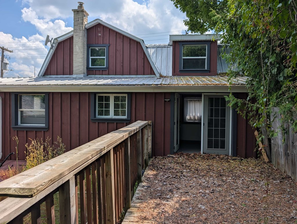A red house with a grey door and windows.