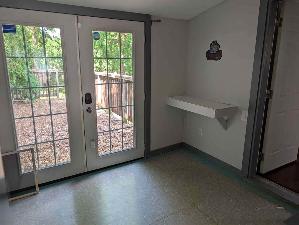 A white door with a glass window is open.