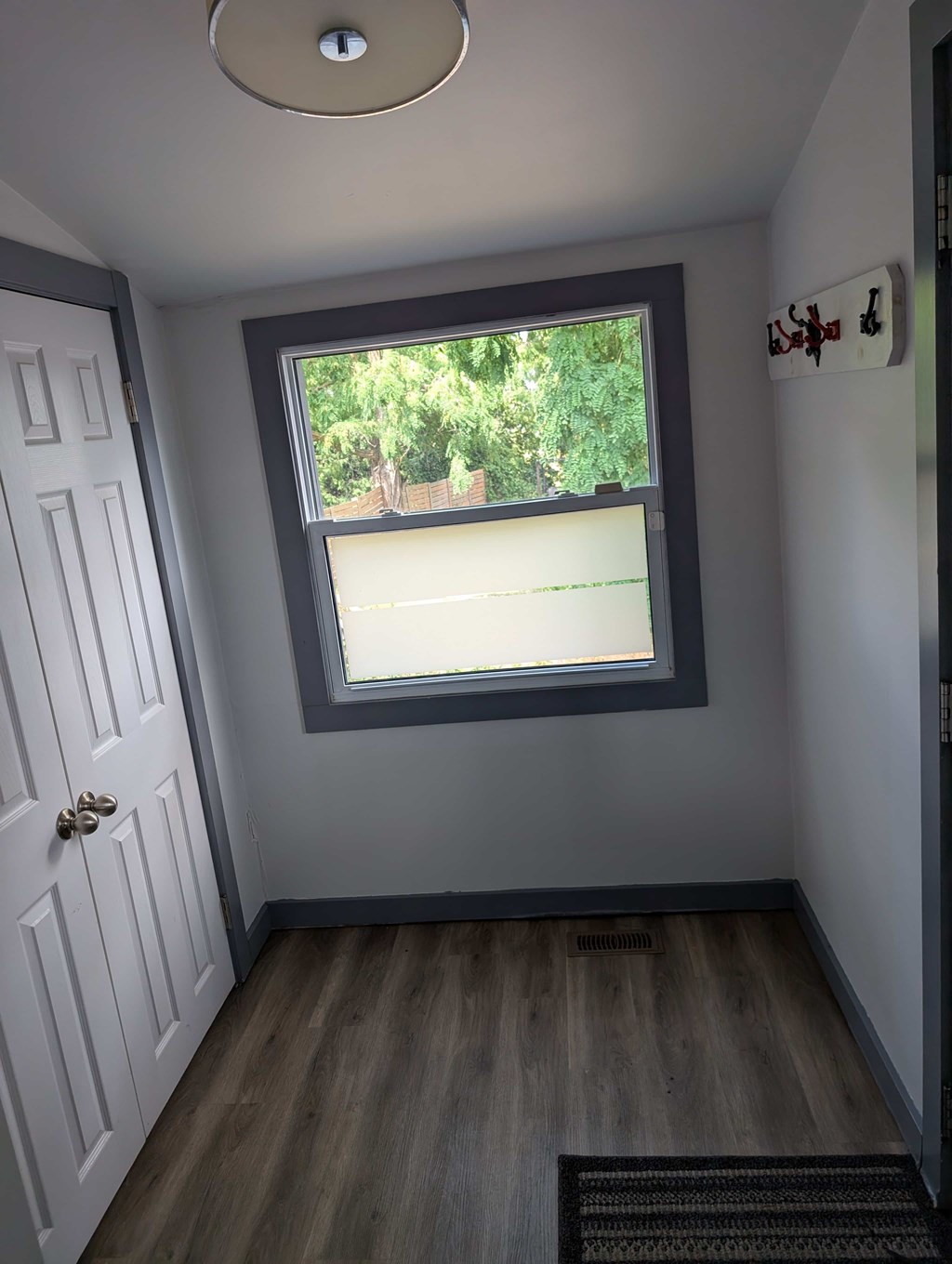 A small room with a window and a door.