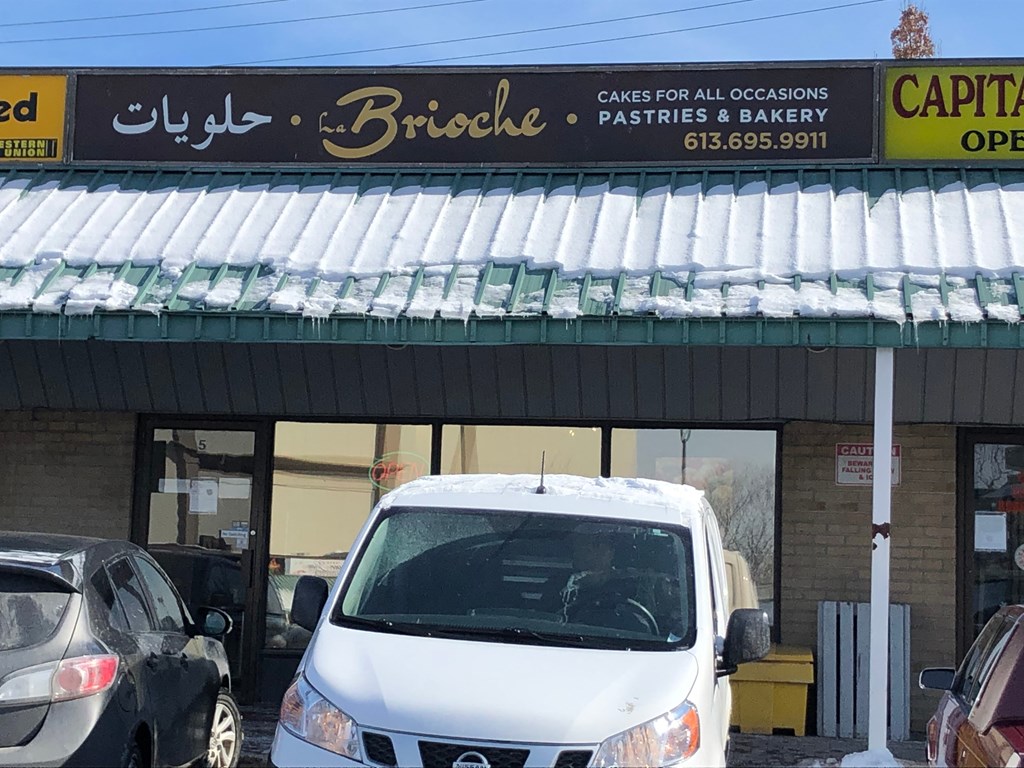 a white car parked in front of a parking lot