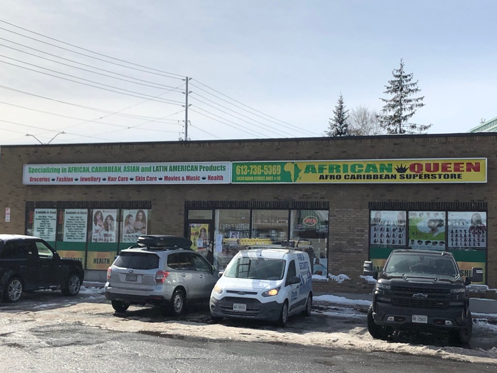 a restaurant with cars parked in front of it