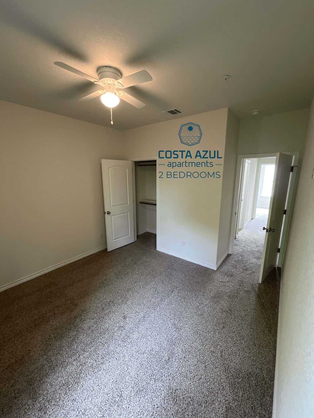 a living room with a ceiling fan and a entrance apartments