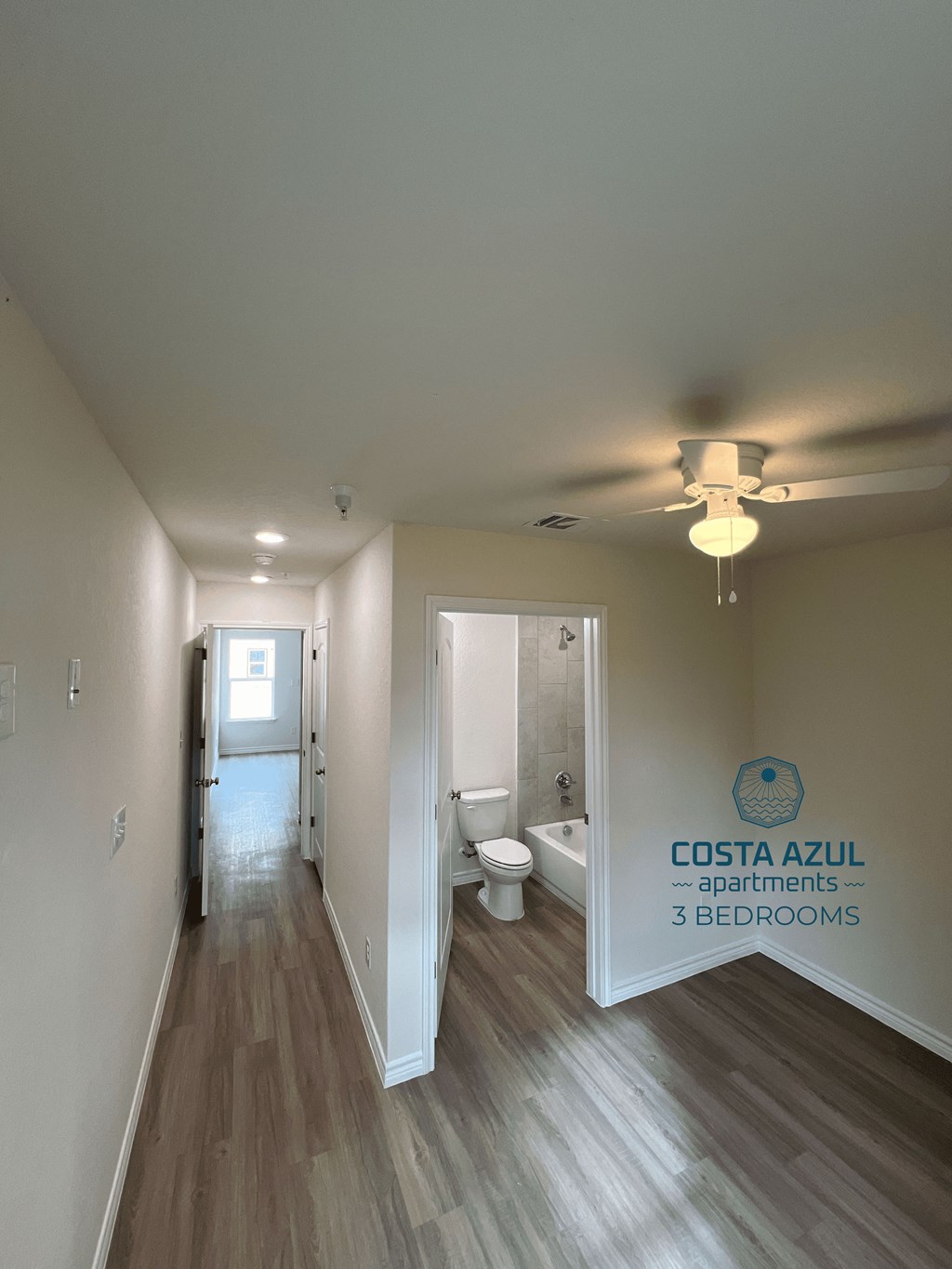 a view of a bathroom from the hallway of a rental home
