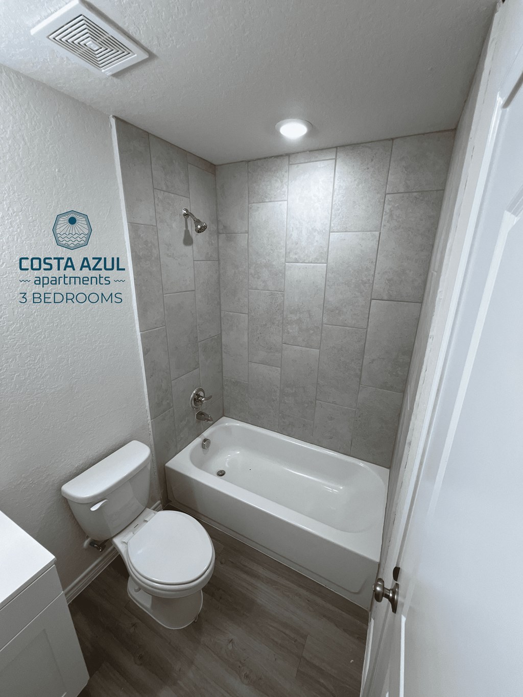 a small bathroom with a toilet and a bath tub