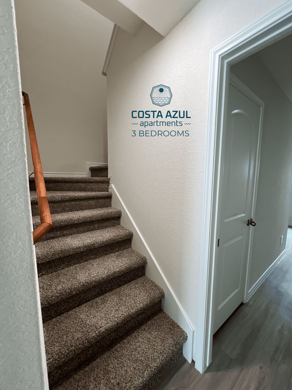 a stairwell with a sign on the wall next to stairs