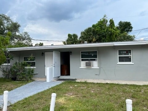 A house with a grey exterior and a brown door.