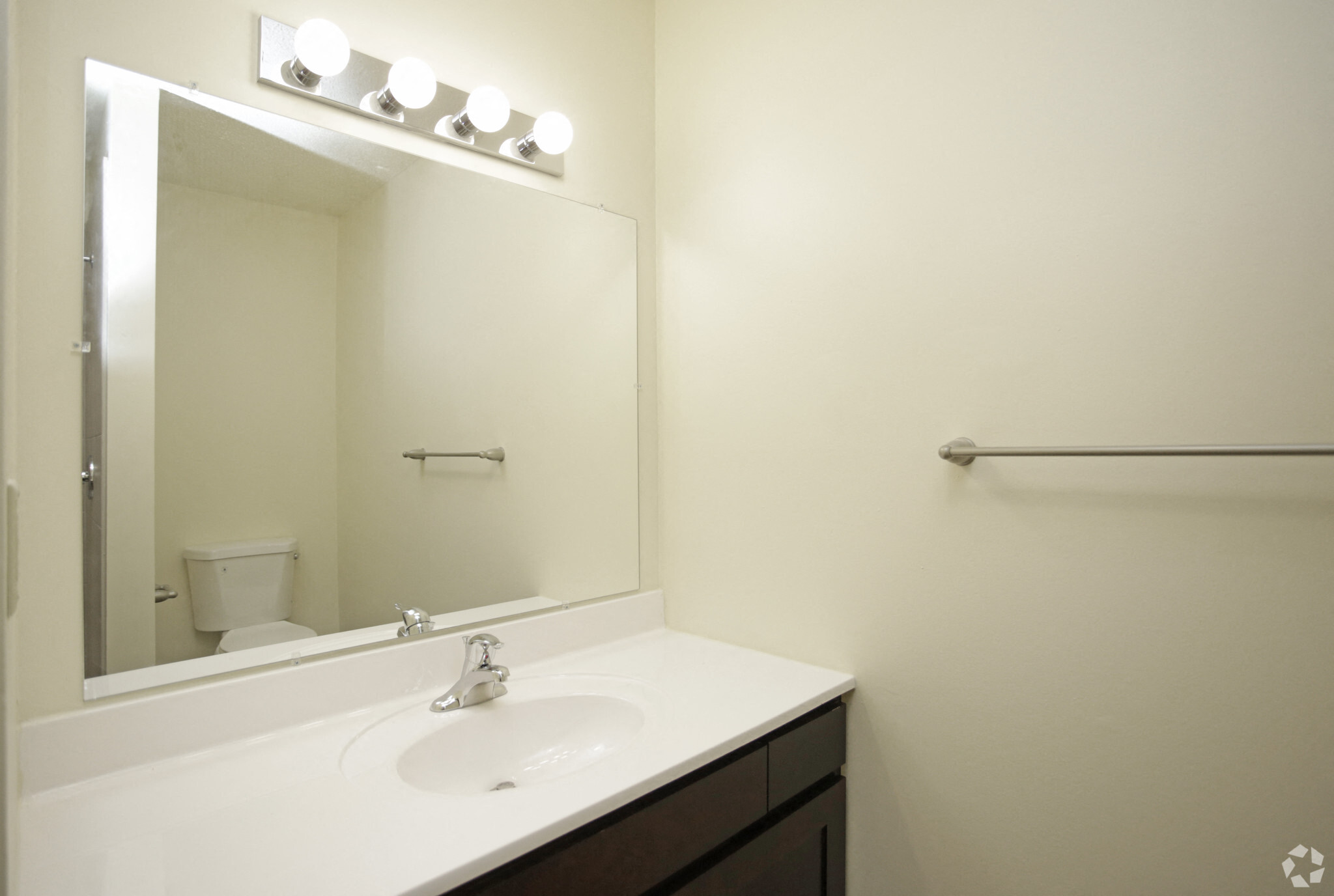 Modern bathroom with vanity lighting and towel rack