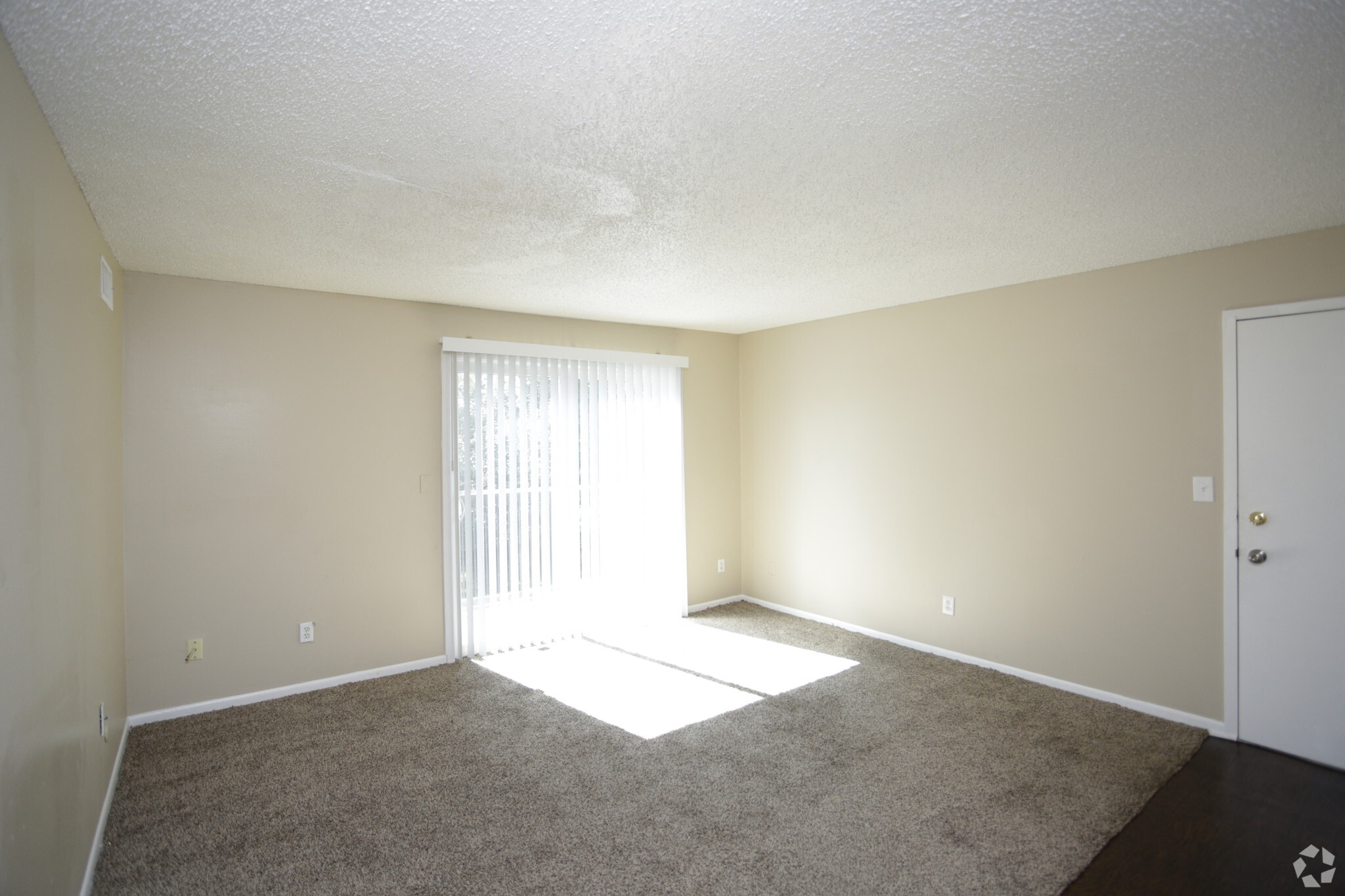 large living room with dark grey carpeting and view of front door
