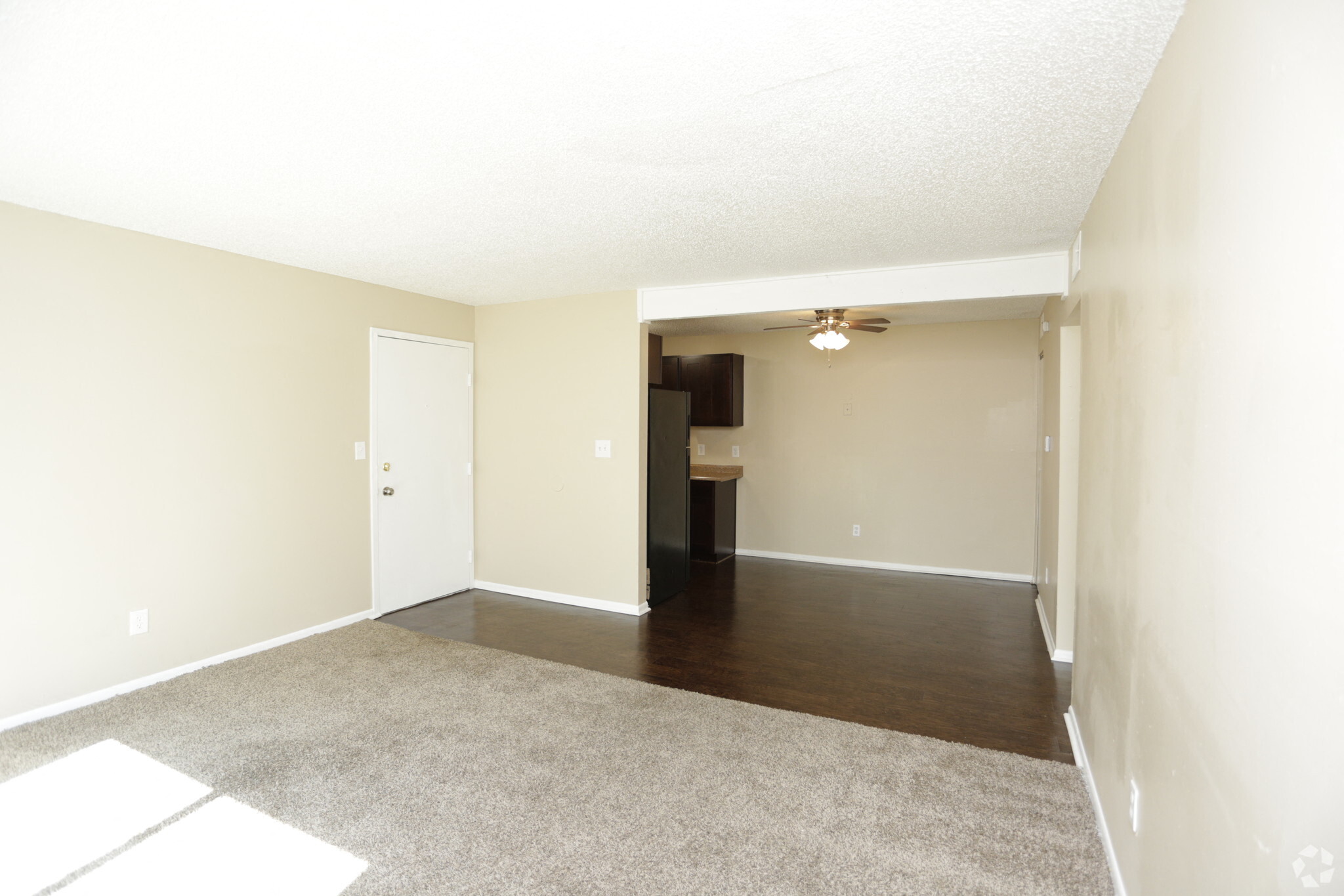 Bright and spacious living room with view of dining area