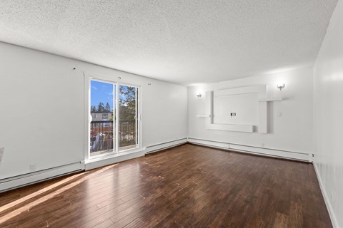 A room with wooden floors and white walls.