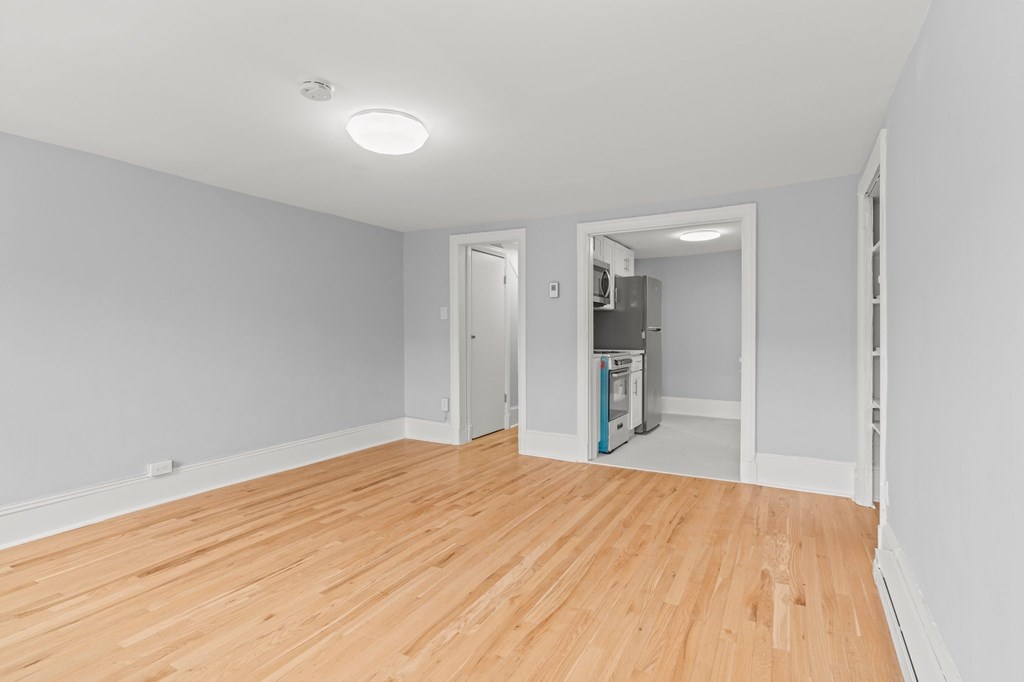A room with wooden floors and white walls.