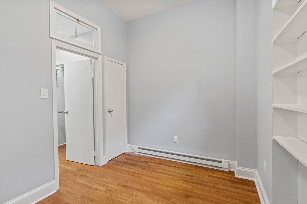 A room with a white door and a white wall.