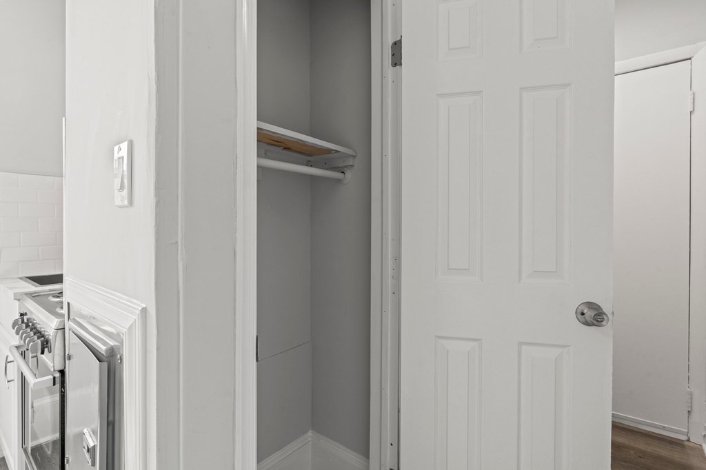 A white door is open to a pantry.